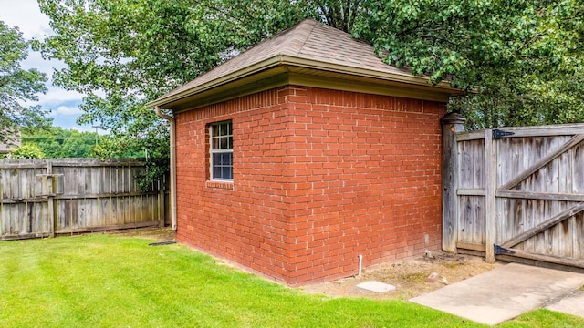 view of outbuilding featuring a lawn