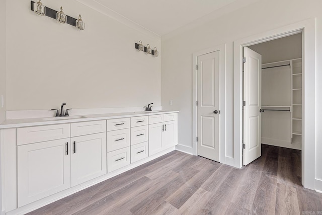 bathroom with hardwood / wood-style flooring and dual vanity