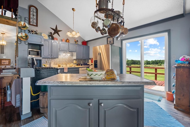 kitchen featuring gray cabinets, sink, backsplash, stainless steel appliances, and dark wood-type flooring