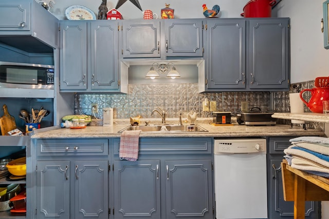 kitchen featuring dishwasher, sink, and decorative backsplash