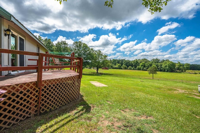 view of yard with a rural view and a wooden deck