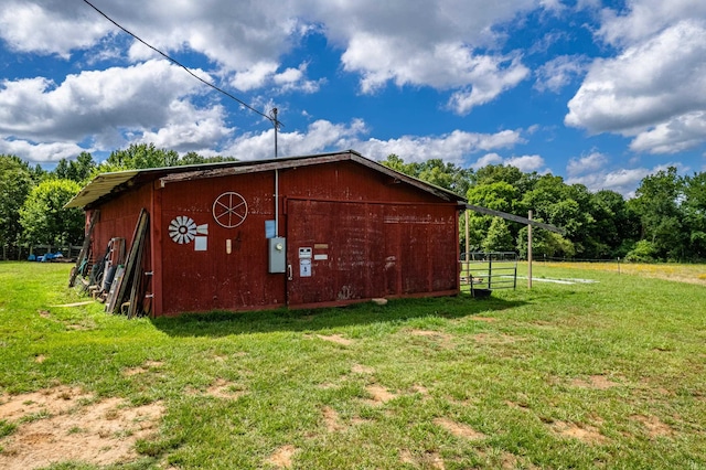 view of outdoor structure featuring a lawn