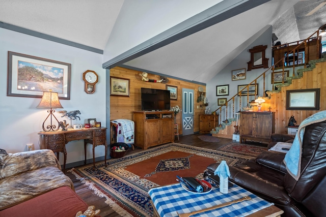 living room with lofted ceiling and wood walls