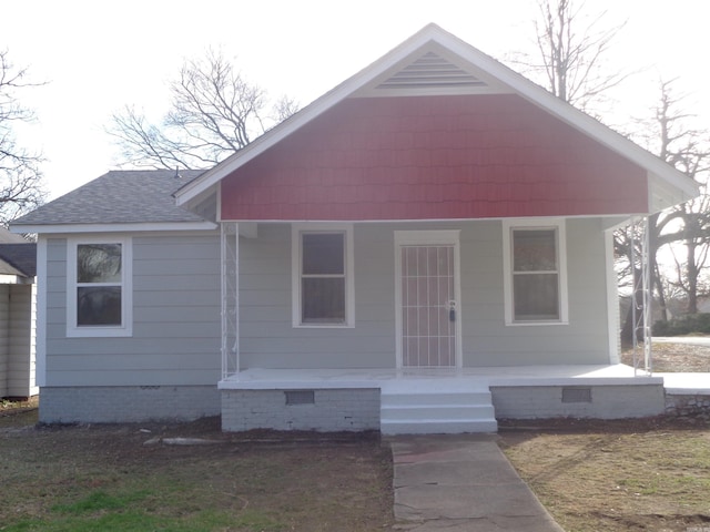 bungalow-style home featuring a porch and a front yard