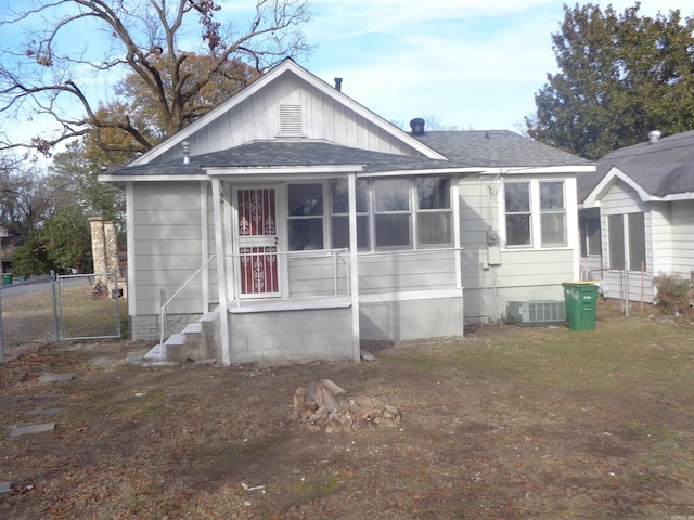 rear view of property with central AC