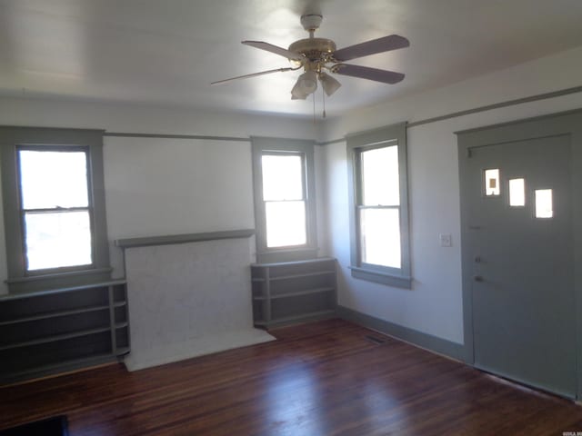 entryway featuring ceiling fan and dark wood-type flooring