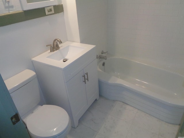 bathroom with vanity, toilet, and a tub to relax in