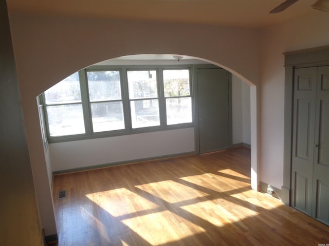 unfurnished room featuring ceiling fan and light wood-type flooring