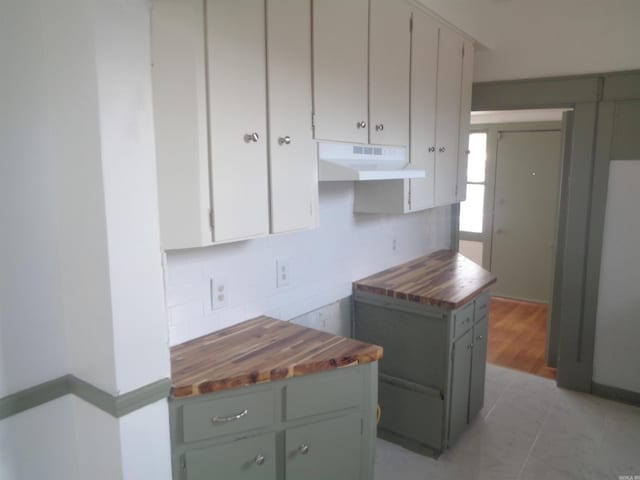 kitchen featuring light tile patterned floors and butcher block countertops