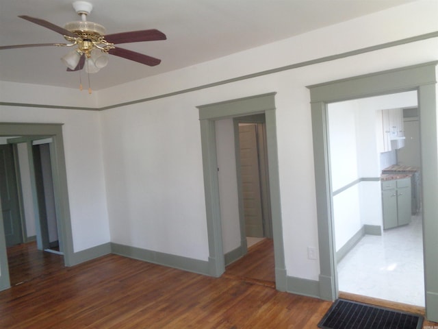 unfurnished room with ceiling fan and dark hardwood / wood-style floors