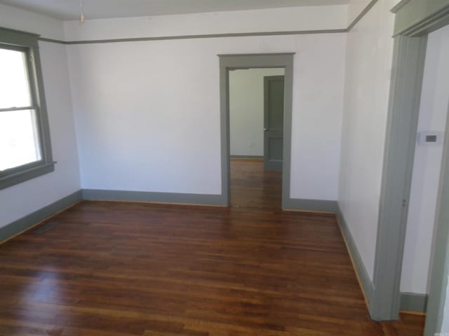 spare room with dark hardwood / wood-style floors