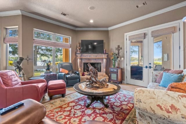 living room featuring crown molding, french doors, a healthy amount of sunlight, and a textured ceiling