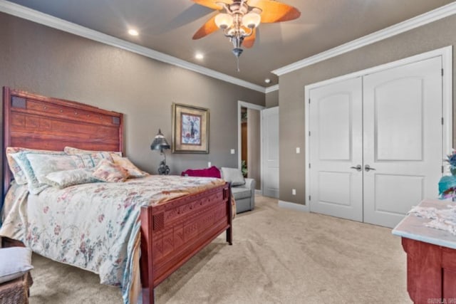 carpeted bedroom featuring a closet, ceiling fan, and ornamental molding