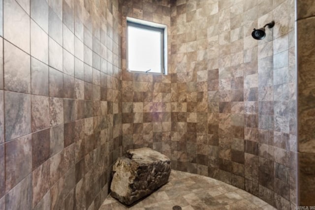 bathroom with a tile shower