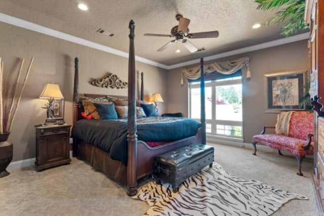 carpeted bedroom featuring a textured ceiling, ceiling fan, and crown molding