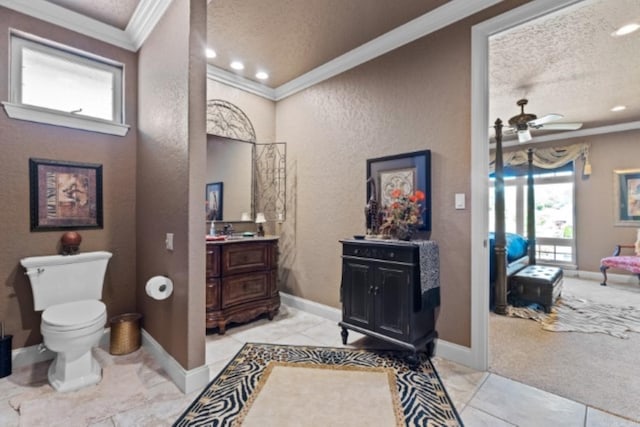 bathroom featuring vanity, ceiling fan, toilet, ornamental molding, and a textured ceiling