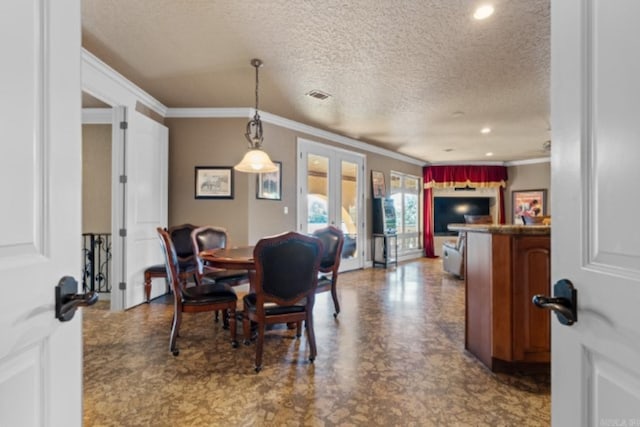 dining area with french doors, a textured ceiling, and crown molding