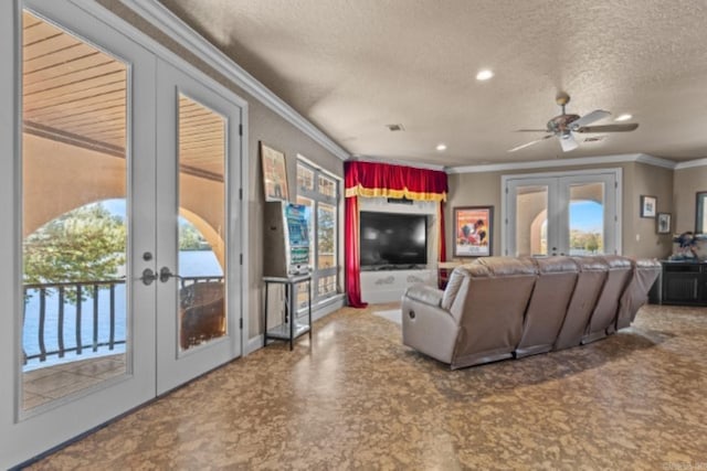 living room featuring ceiling fan, crown molding, a textured ceiling, and french doors