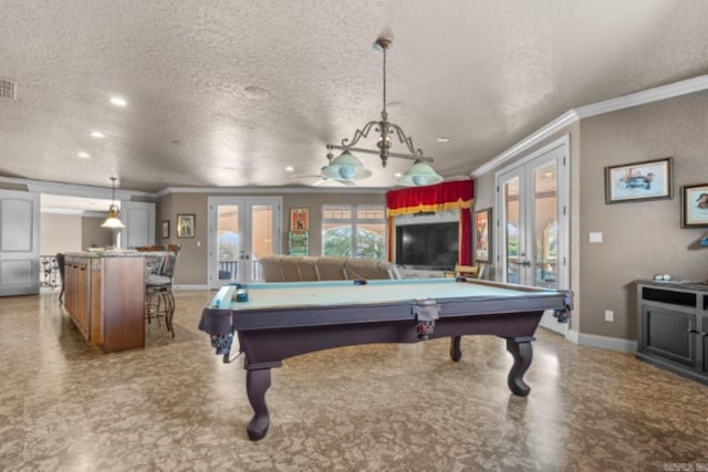 game room featuring french doors, ornamental molding, a textured ceiling, and billiards