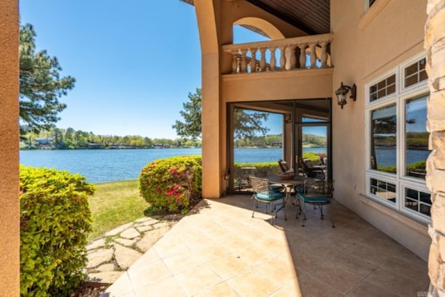 view of patio / terrace featuring a water view and a balcony