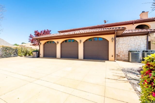 mediterranean / spanish-style home with central AC unit