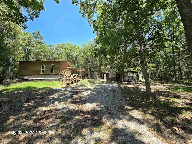 view of yard with a storage shed and a deck