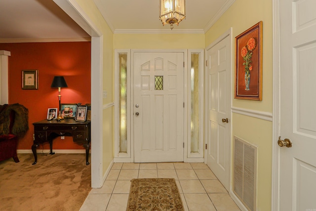 foyer featuring light tile patterned floors and ornamental molding