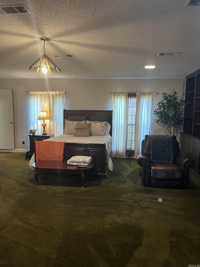 carpeted bedroom featuring a textured ceiling and ceiling fan