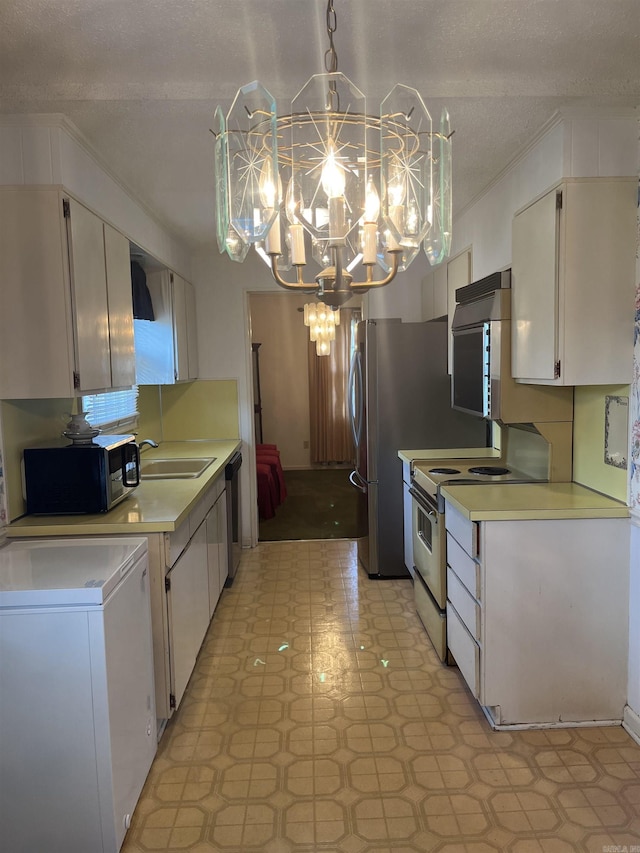 kitchen featuring white cabinetry, sink, hanging light fixtures, a chandelier, and electric stove