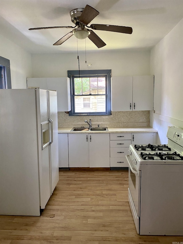 kitchen with sink, light hardwood / wood-style flooring, backsplash, white appliances, and white cabinets