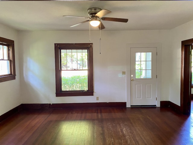 interior space with ceiling fan and dark hardwood / wood-style floors