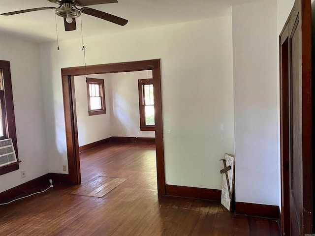 spare room with ceiling fan and dark hardwood / wood-style flooring