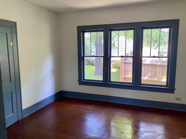 spare room with dark hardwood / wood-style flooring