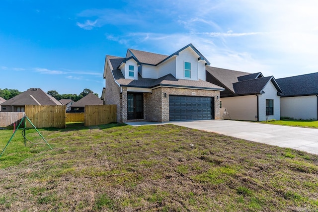 view of front of home featuring a garage and a front lawn