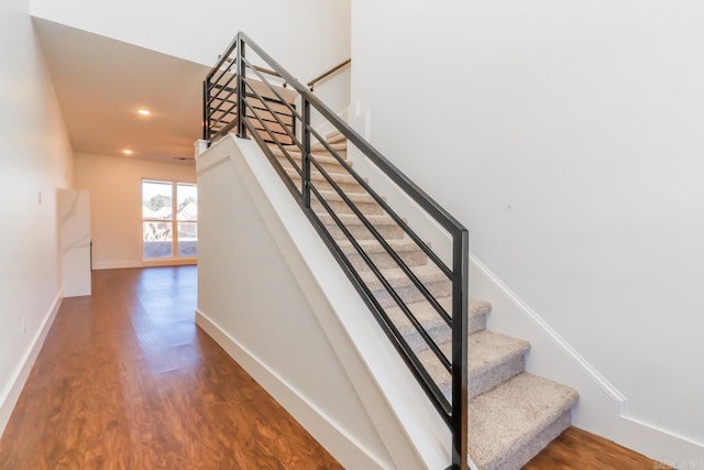 stairs featuring hardwood / wood-style flooring