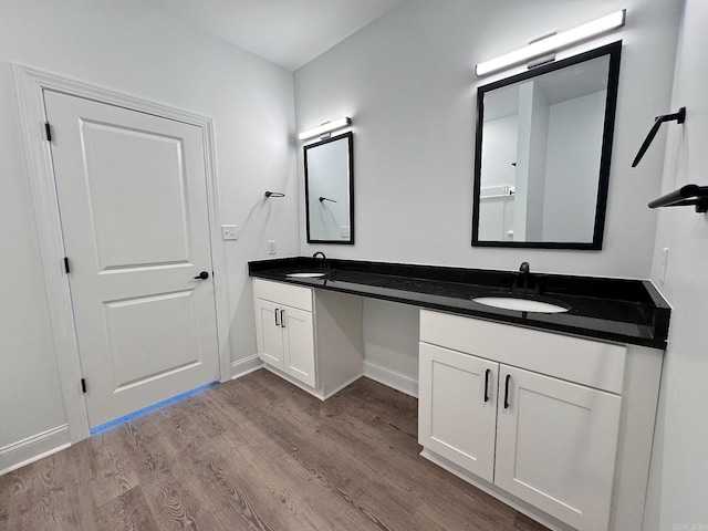 bathroom featuring hardwood / wood-style flooring and double vanity