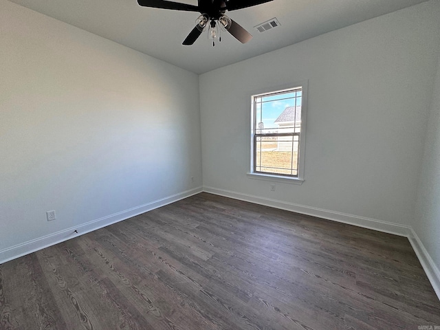 empty room with dark hardwood / wood-style flooring and ceiling fan