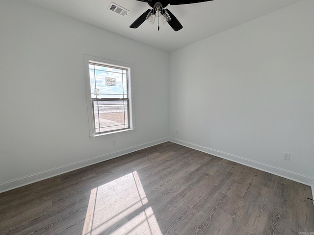 spare room featuring dark hardwood / wood-style flooring and ceiling fan