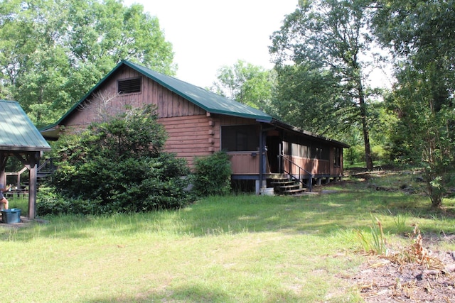 152 Hempstead 336, Mccaskill, AR 71847 - view of home's exterior featuring metal roof and a lawn