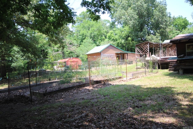 152 Hempstead 336, Mccaskill, AR 71847 - view of yard featuring a garden, a wooden deck, and an outbuilding