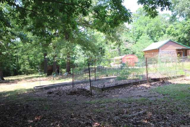 152 Hempstead 336, Mccaskill, AR 71847 - view of yard featuring a garden and a wooded view