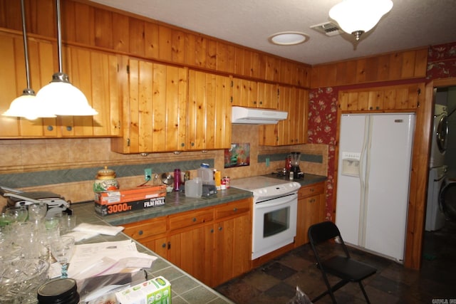 152 Hempstead 336, Mccaskill, AR 71847 - kitchen featuring white appliances, under cabinet range hood, stacked washer / drying machine, brown cabinets, and tile countertops