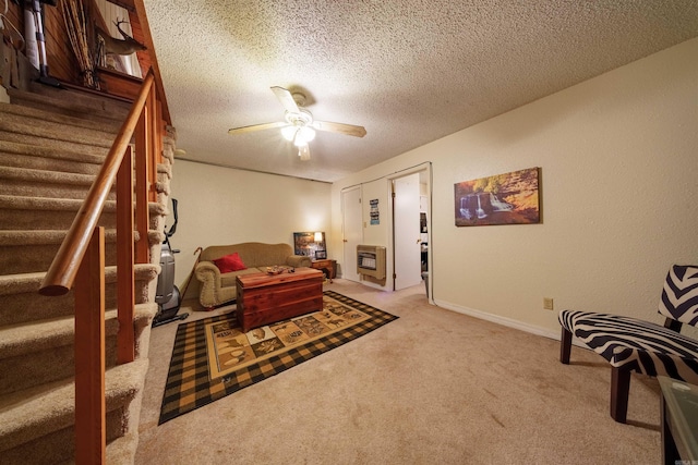 living area with carpet flooring, a textured ceiling, and ceiling fan