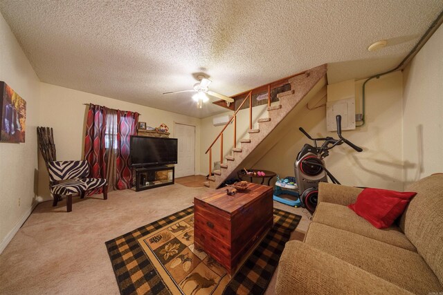 living room with a textured ceiling, carpet floors, and ceiling fan