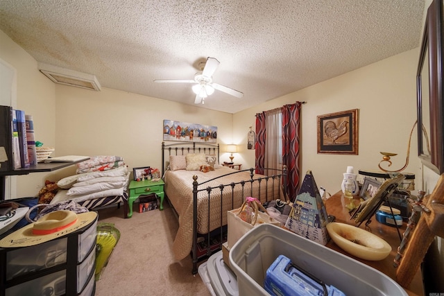 carpeted bedroom with a textured ceiling and ceiling fan