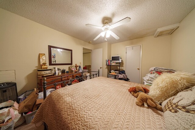 bedroom featuring a textured ceiling and ceiling fan