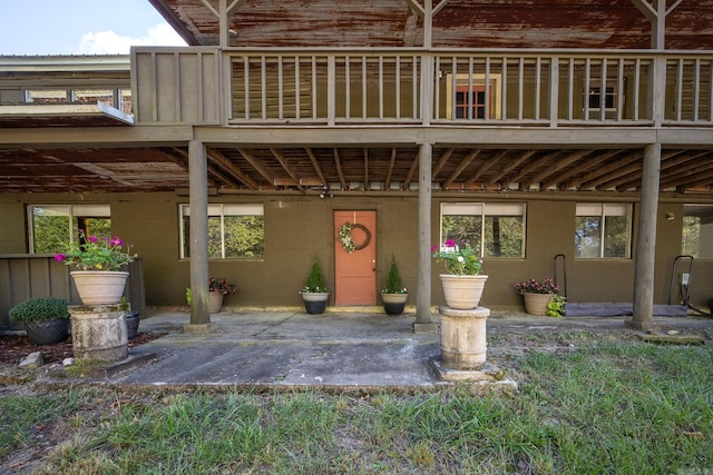 view of exterior entry featuring a patio