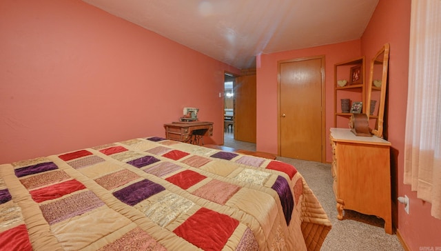 bedroom with light colored carpet and a closet