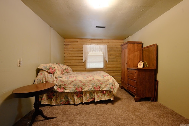 carpeted bedroom featuring log walls