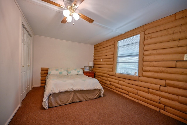 bedroom with carpet flooring and log walls